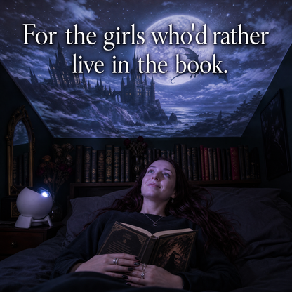 A reader lies in bed under a castle and moon projected on her ceiling