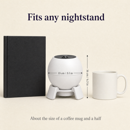 Nightlore projector size: 13 cm / 5.1 in across, 16 cm / 6.3 in tall, beside a hardcover book and a mug